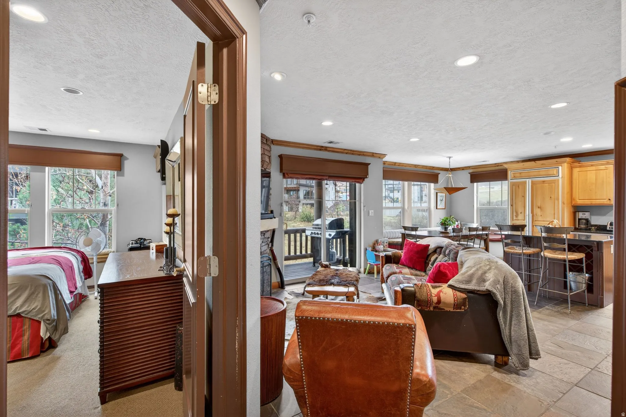 Living area with a textured ceiling and recessed lighting