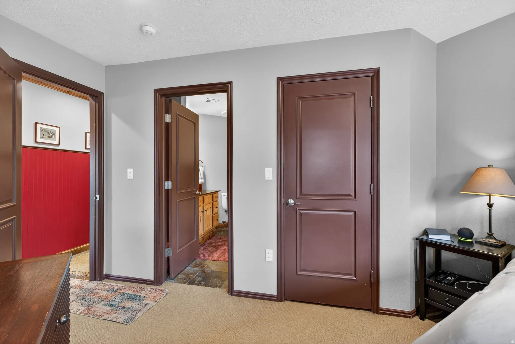 Bedroom with light carpet and a textured ceiling