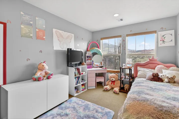Bedroom featuring light carpet