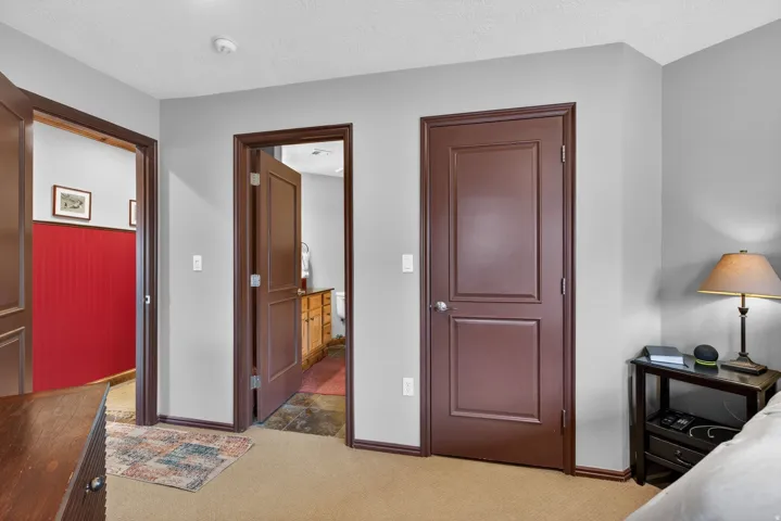 Bedroom with light carpet and a textured ceiling