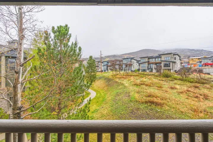 View of yard with a balcony