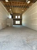 Miscellaneous room with concrete floors and a garage