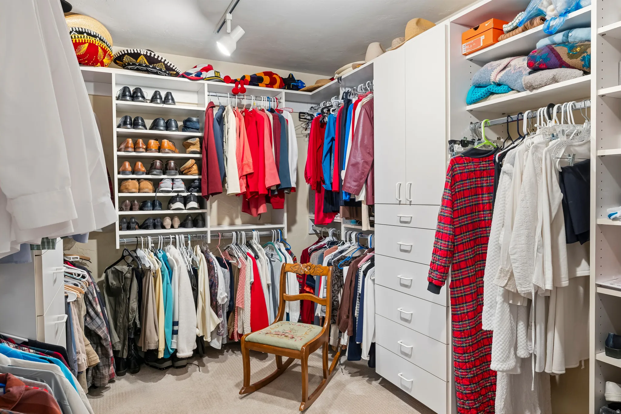 Walk in closet with light colored carpet