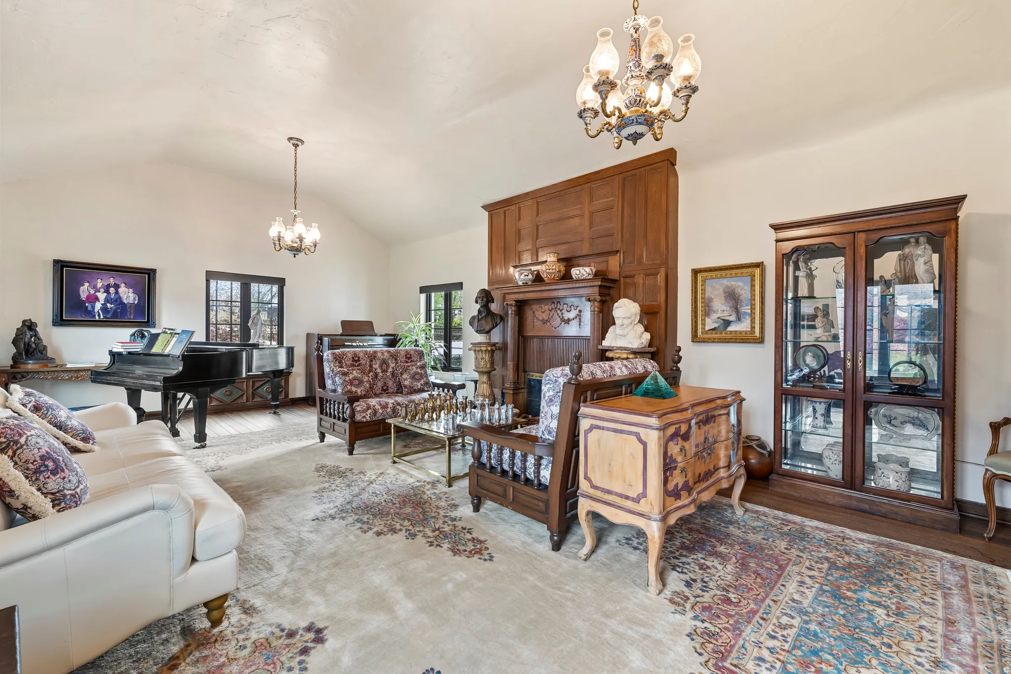 Living room featuring a chandelier, wood finished floors, and lofted ceiling