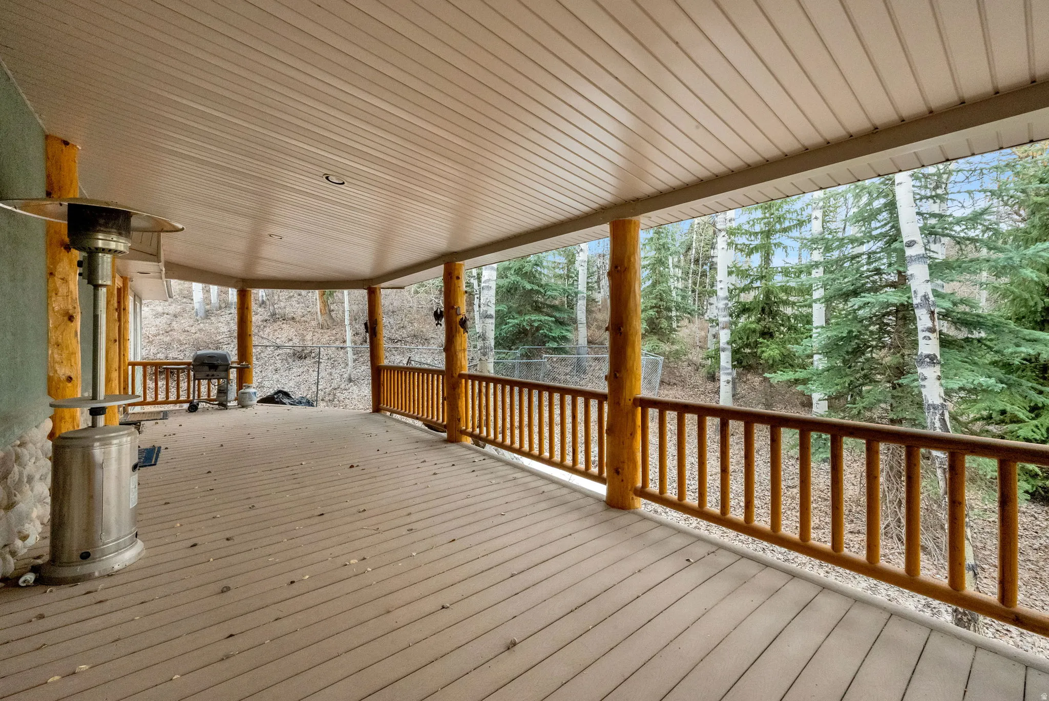Wooden deck featuring a grill