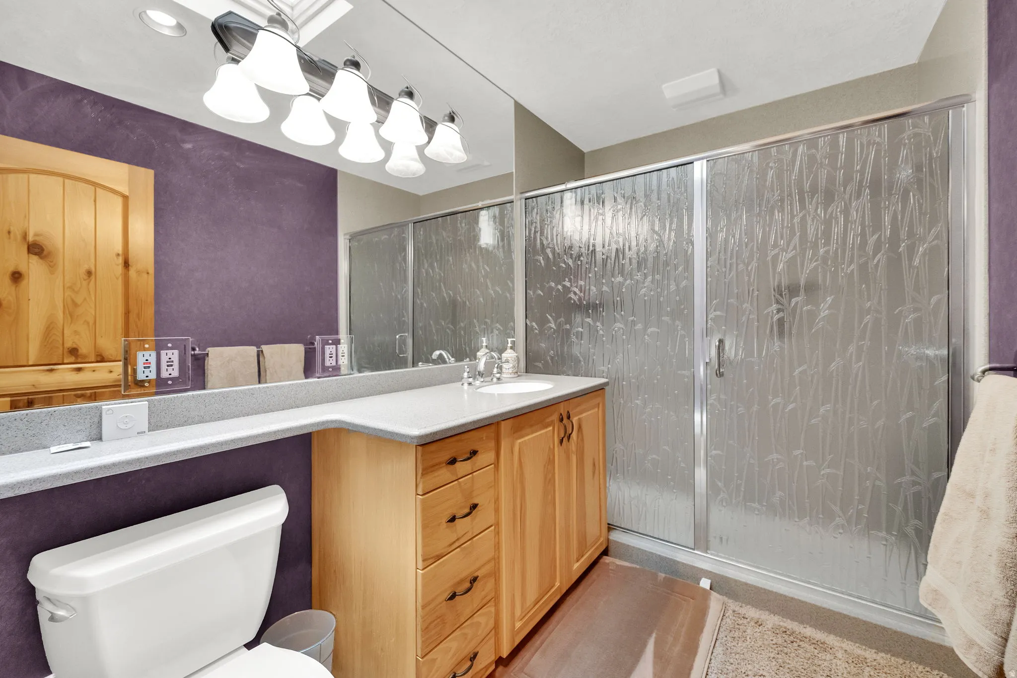 Full bathroom featuring vanity and a shower stall
