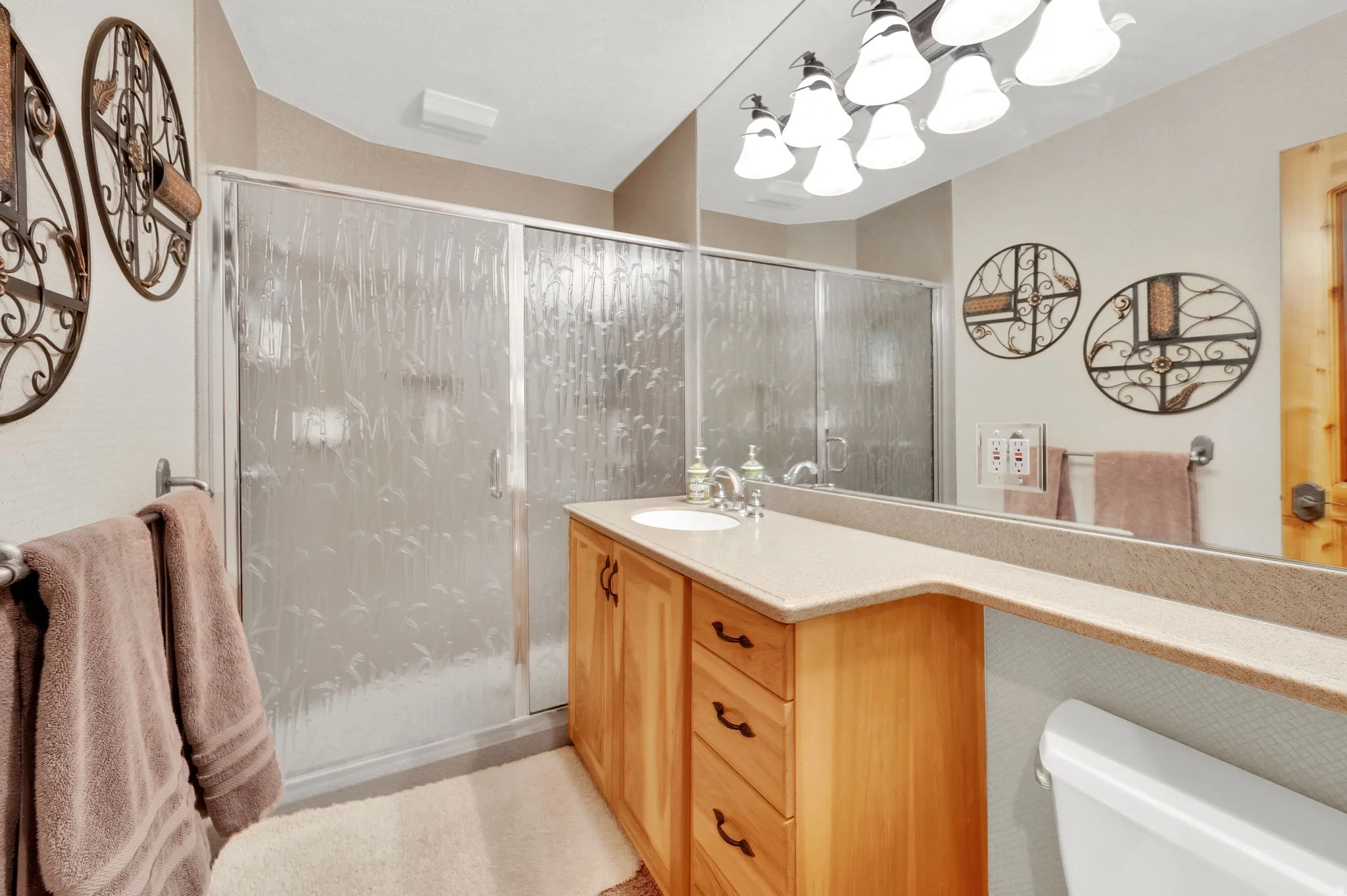 Bathroom featuring vanity and a shower stall