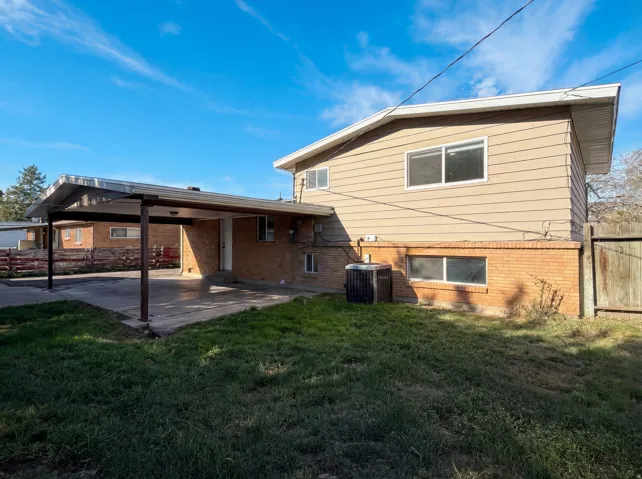 Rear view of house featuring brick siding and a patio