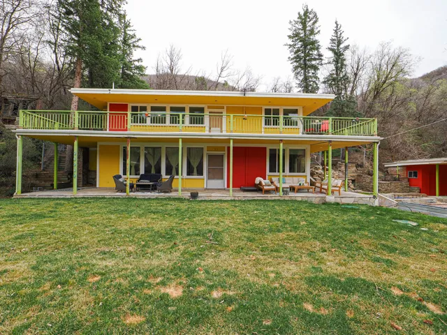 View of front of property with a front yard, a patio, and board and batten siding