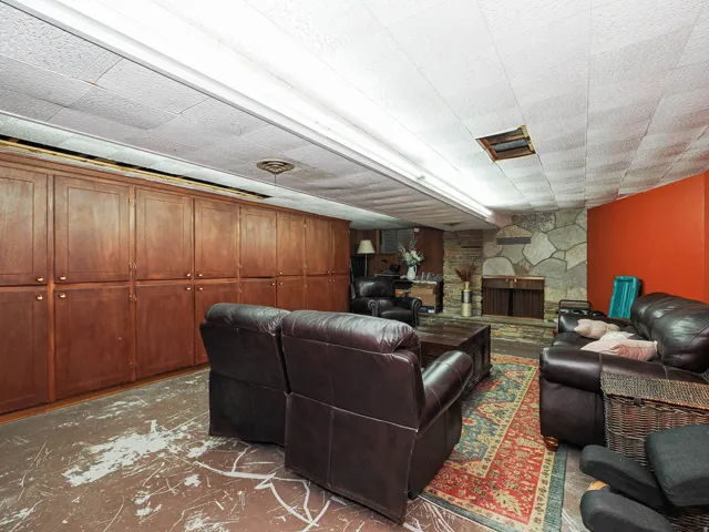 Living area featuring a stone fireplace