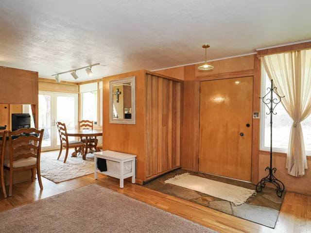 Foyer entrance featuring hardwood / wood-style flooring, a textured ceiling, and rail lighting