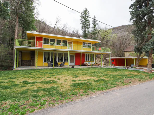 View of front of property featuring a front yard and stone siding