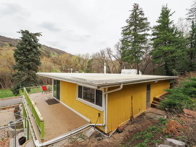 View of side of home with a mountain view
