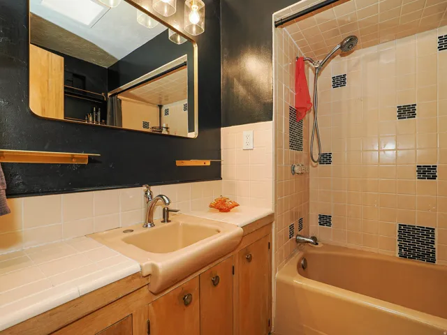 Full bathroom featuring vanity, bathtub / shower combination, and decorative backsplash