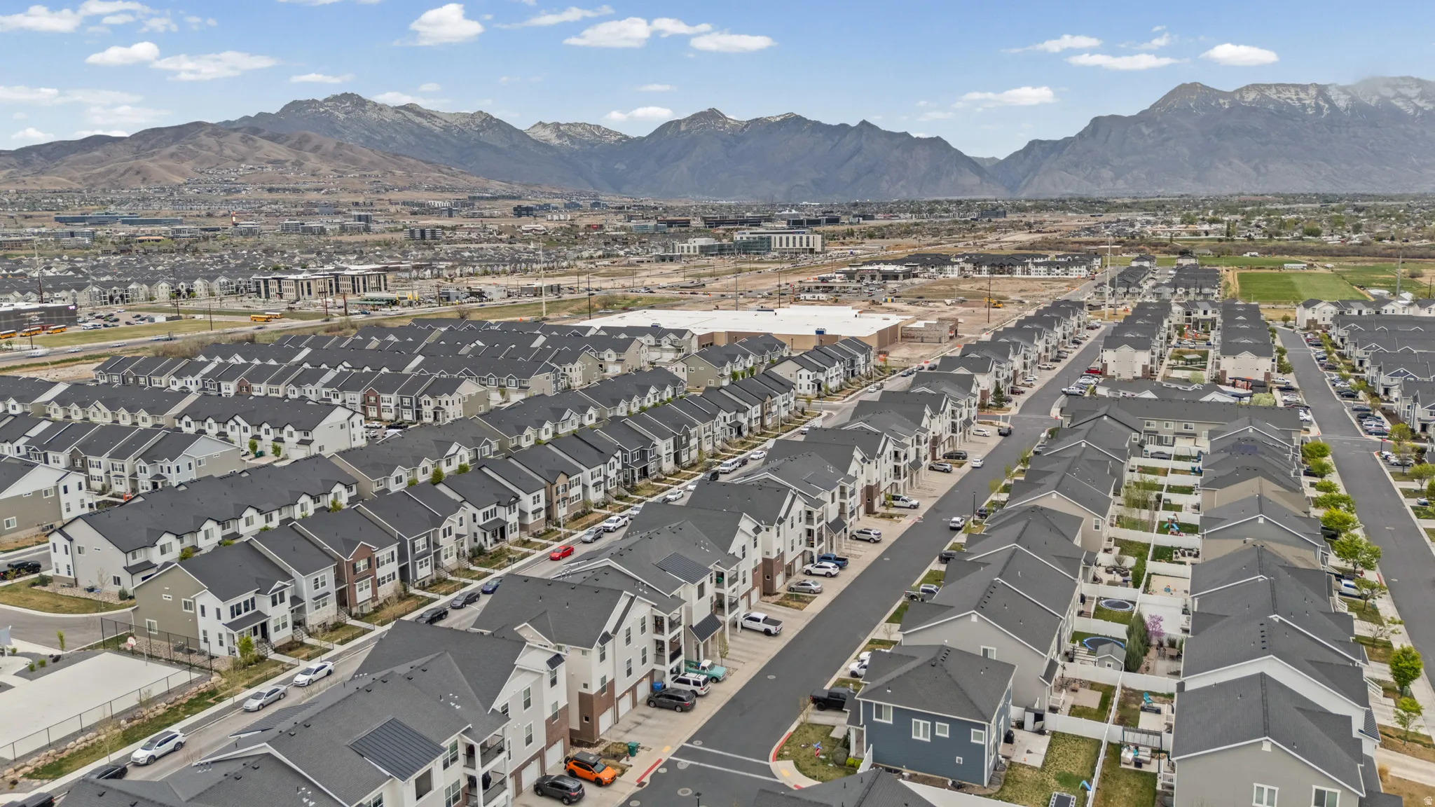 Aerial perspective of suburban area featuring a mountain backdrop