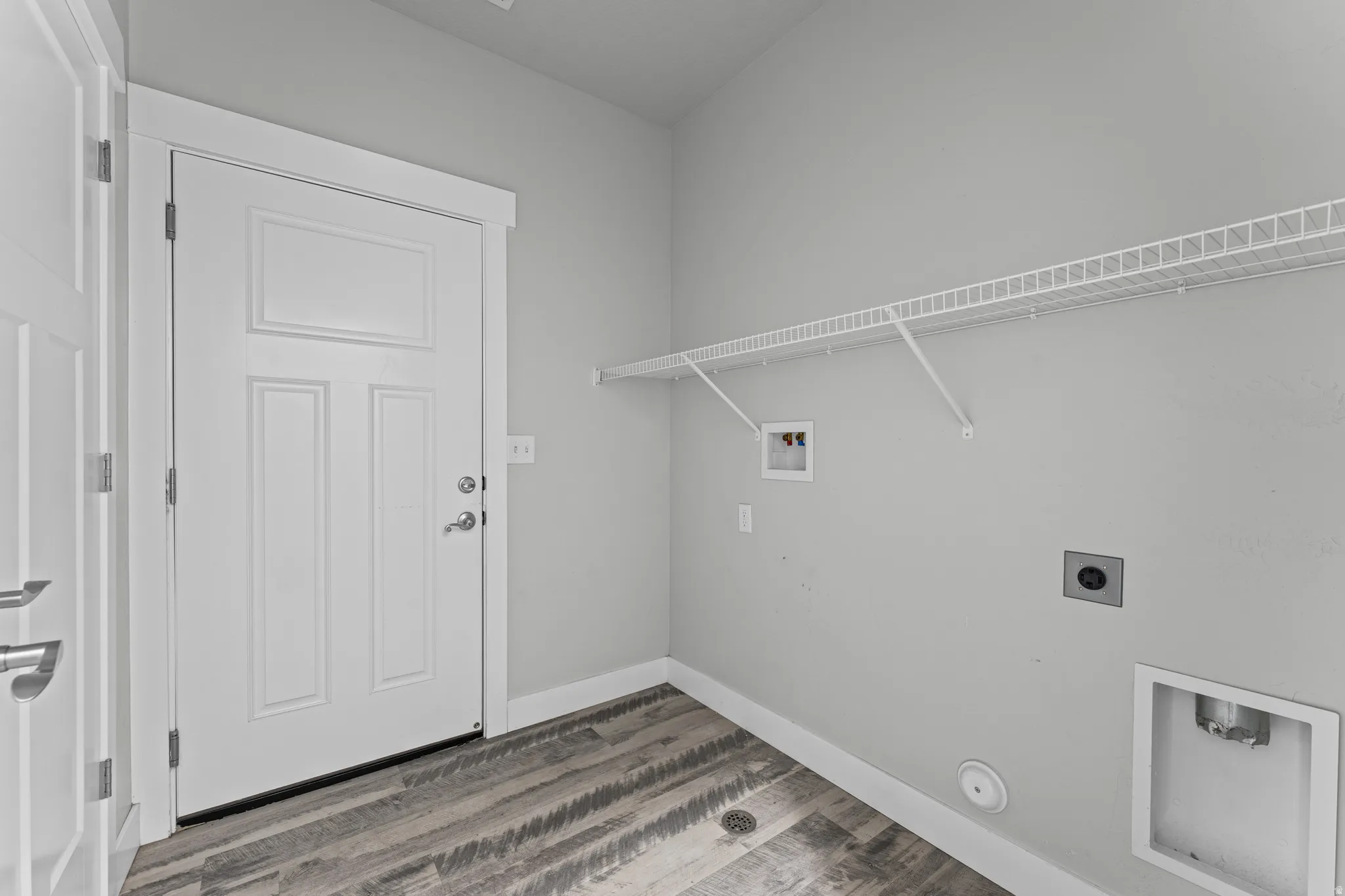 Laundry room with hookup for a washing machine, dark wood-style floors, and electric dryer hookup