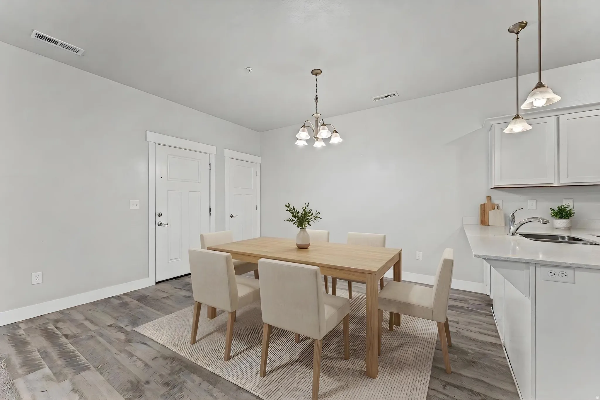 Dining room featuring light wood-type flooring and a chandelier