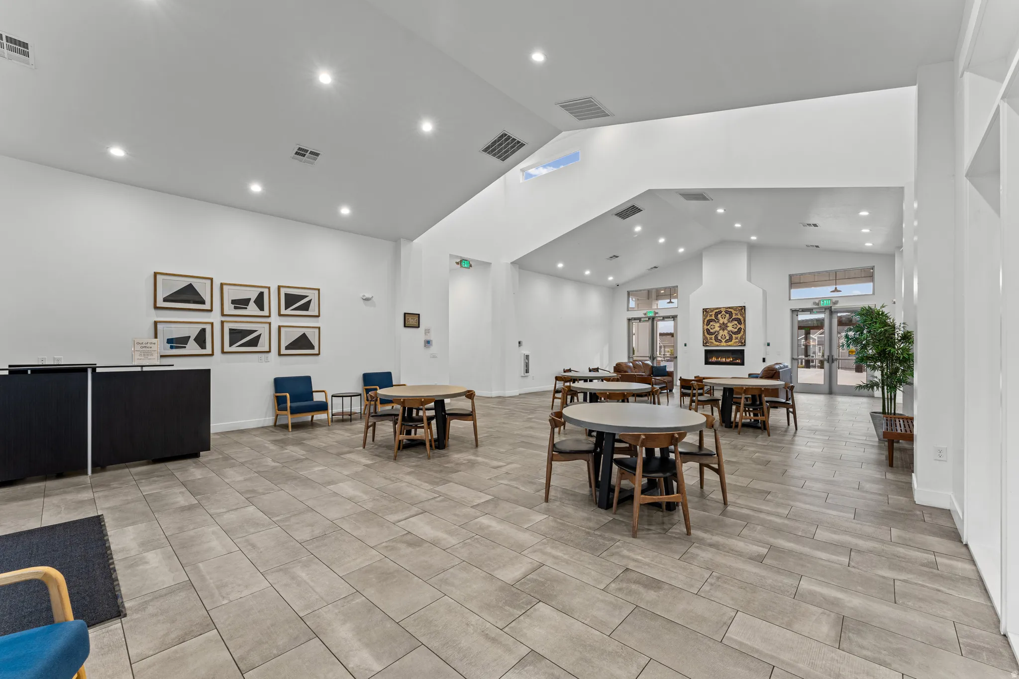 Dining area with a high ceiling and recessed lighting