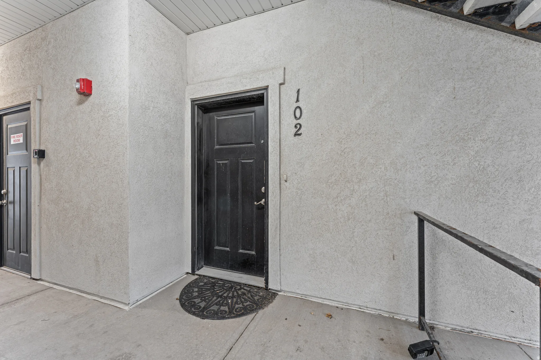 View of exterior entry featuring stucco siding