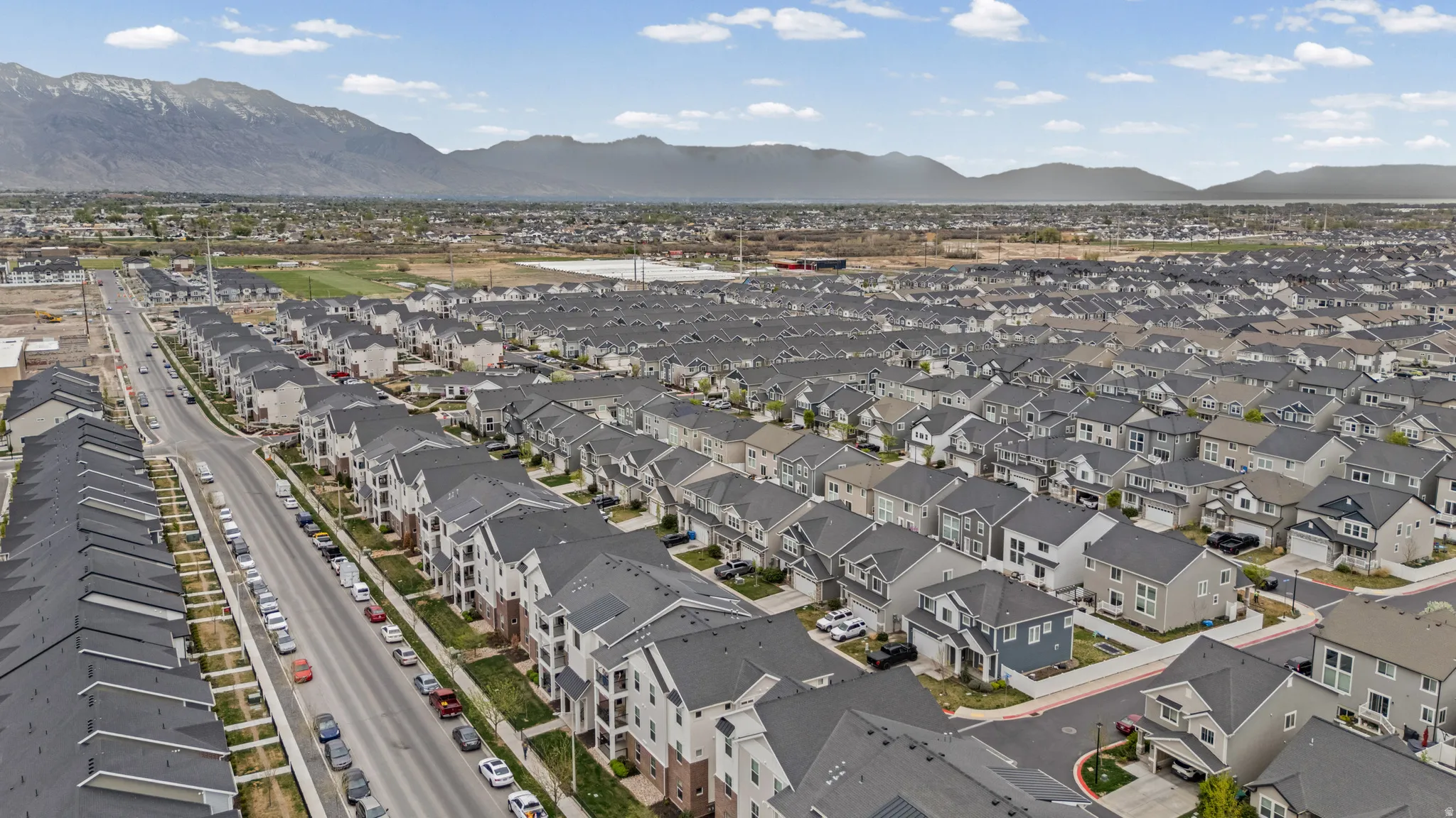 Aerial perspective of suburban area with a mountainous background