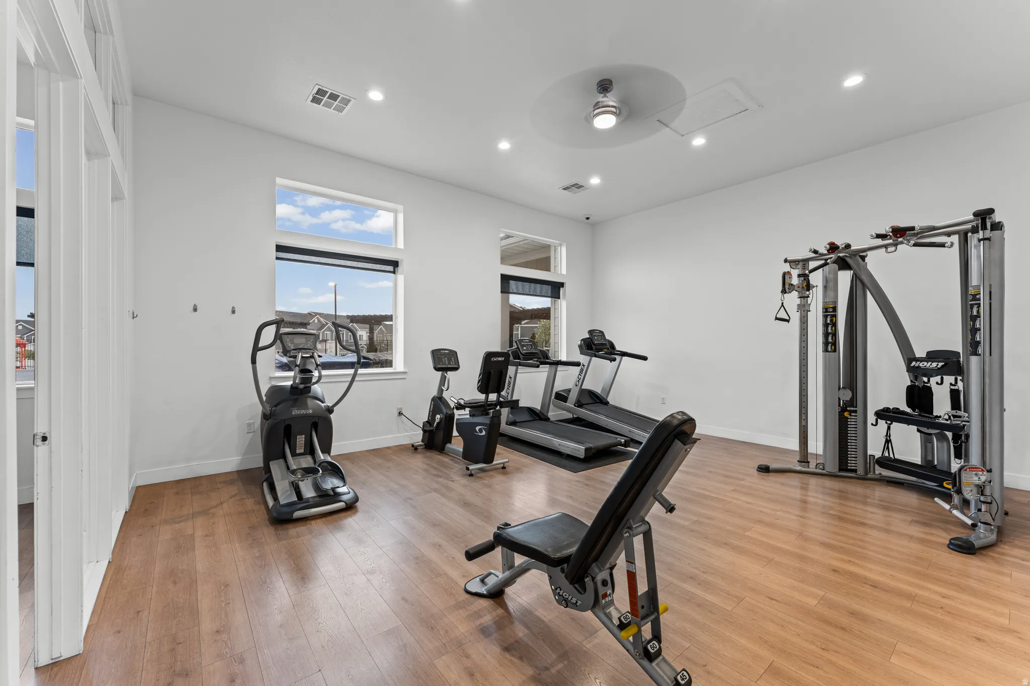 Workout area with a ceiling fan and recessed lighting