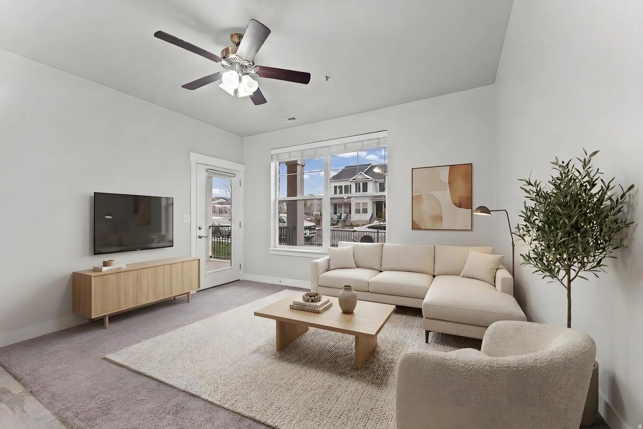 Living room with a ceiling fan and baseboards