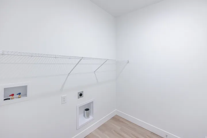 White wire shelving, wood-finish flooring, and white walls