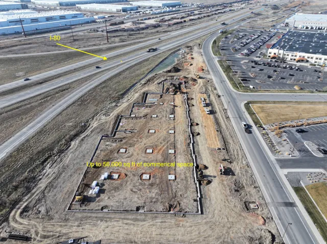 Aerial view of property's location with property parcel outlined and a main thoroughfare