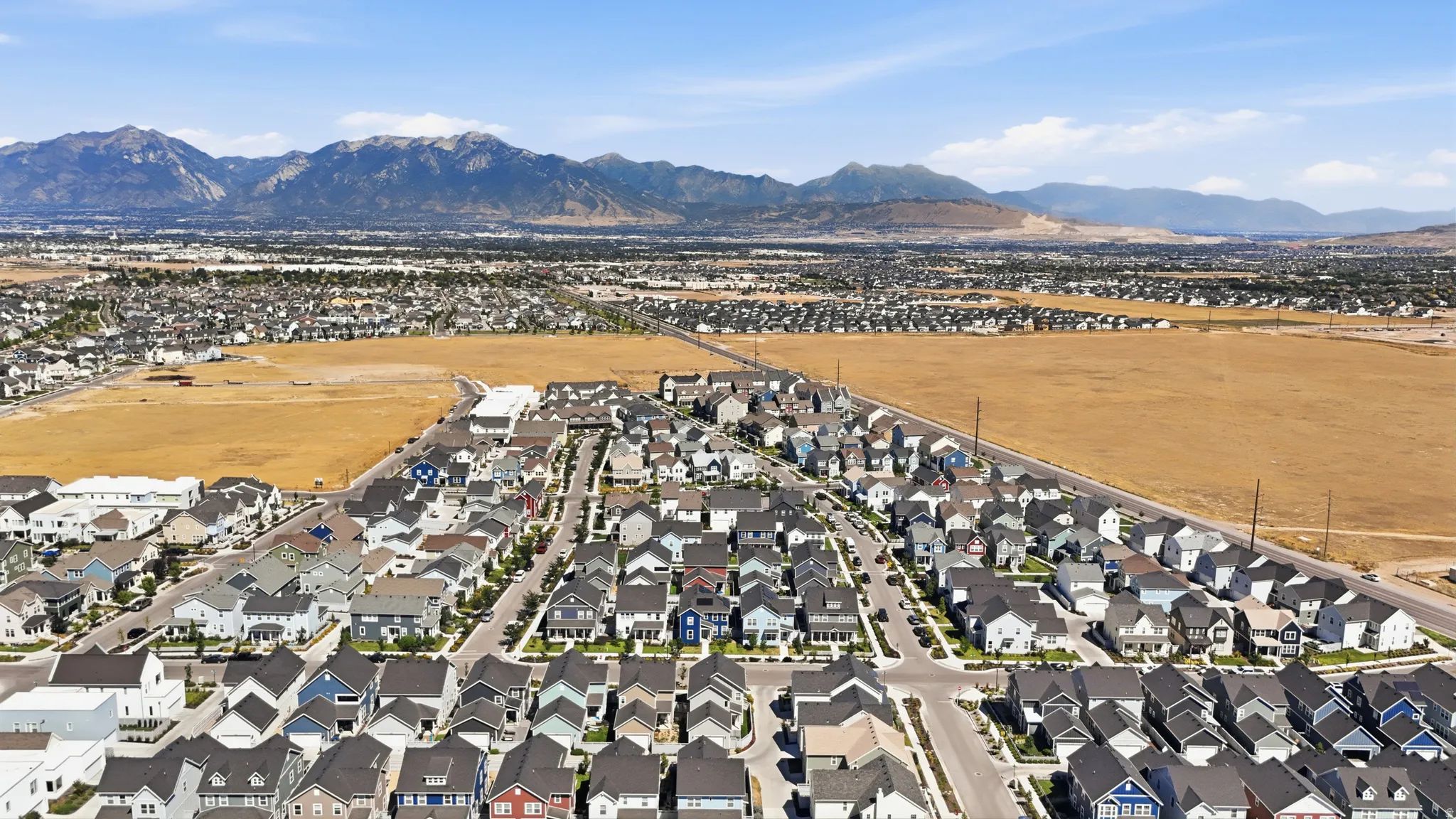 Expansive residential development featuring a variety of single-family homes with mountain backdrops