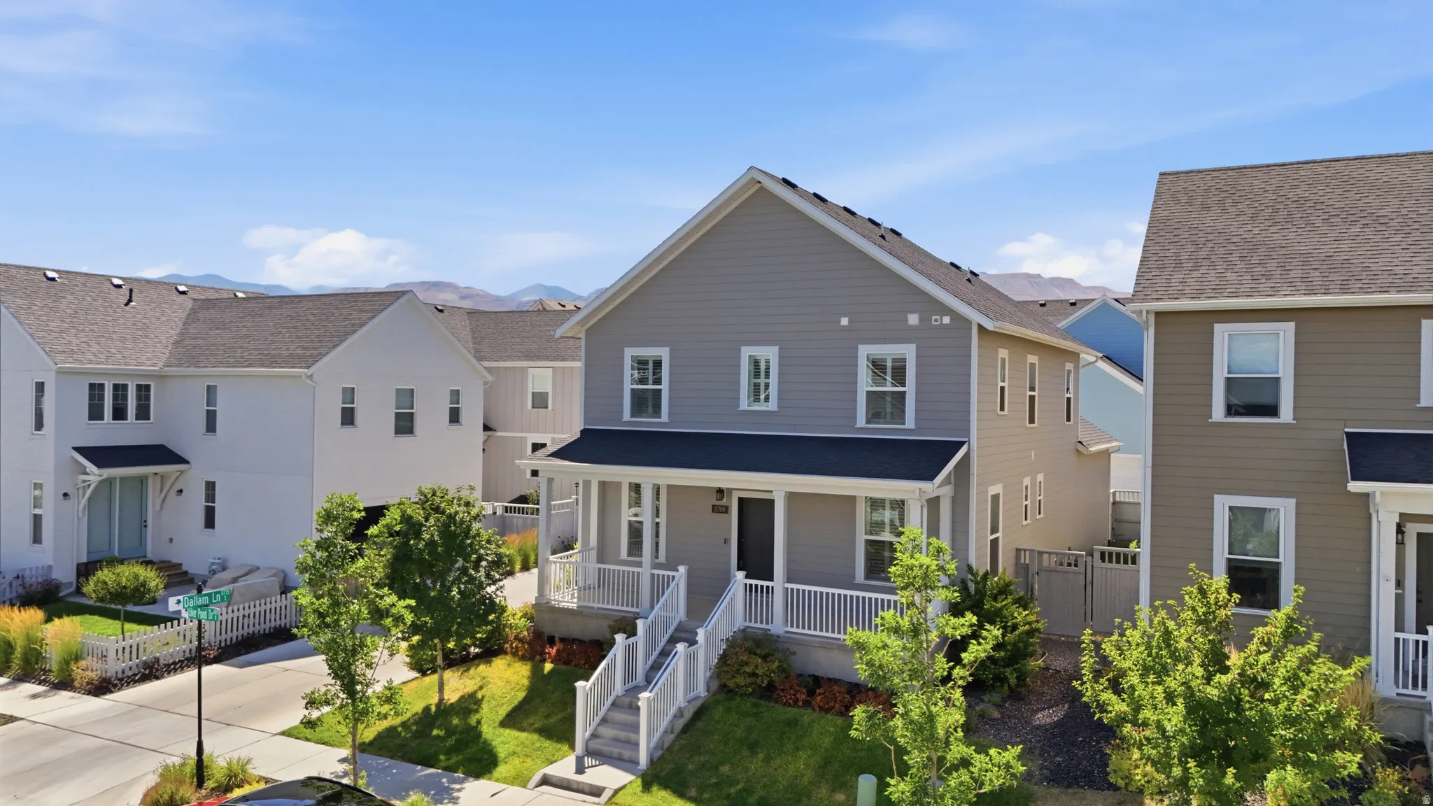 Two-story residence featuring light gray siding with white trim accents