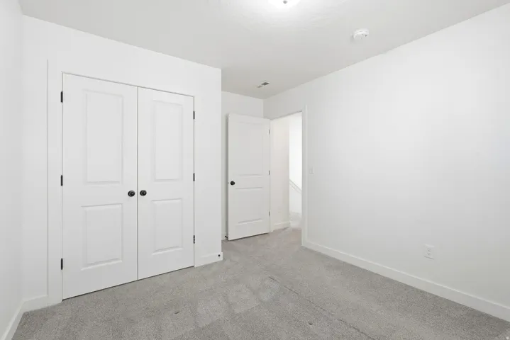 Room featuring light gray carpet, white walls, and white trim