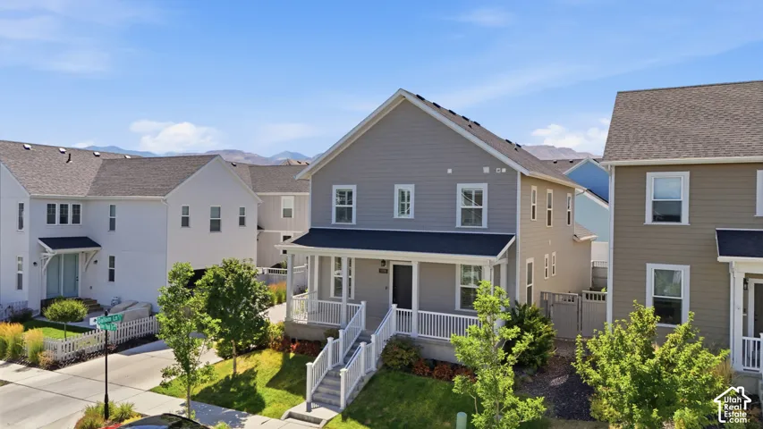 Two-story residence featuring light gray siding with white trim accents