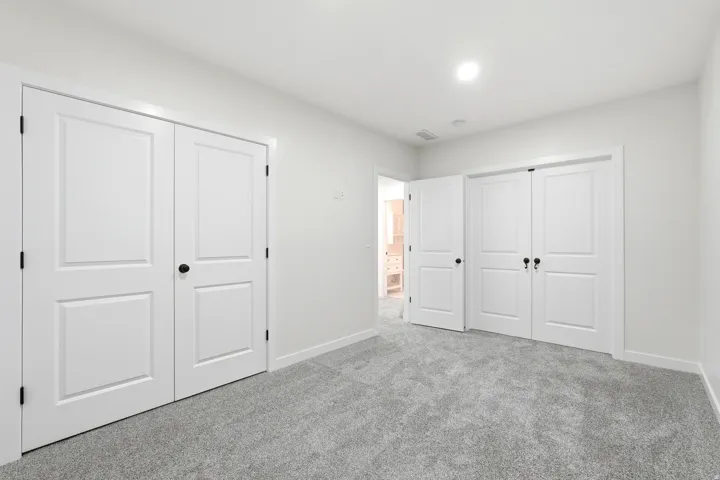 Neutral-toned carpeting paired with crisp white walls and baseboards