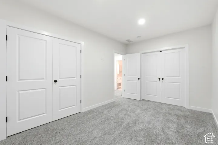 Neutral-toned carpeting paired with crisp white walls and baseboards