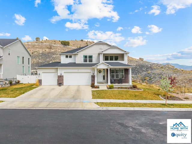 Beautiful home with a covered porch, a mountain view, and a 3-car garage.