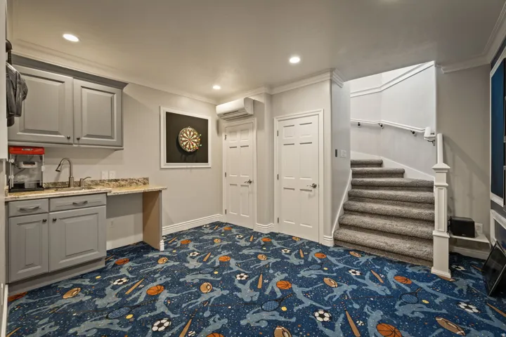 Mudroom with dark colored carpet, ornamental molding, and recessed lighting