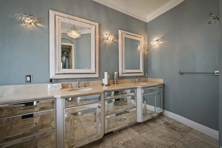 Bathroom featuring double vanity and ornamental molding