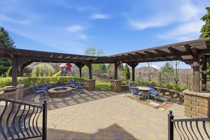 View of patio / terrace with a pergola, a fire pit, and outdoor dining area