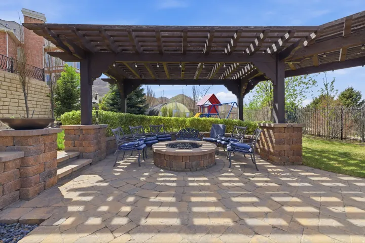 View of patio with an outdoor fire pit, a playground, and a pergola
