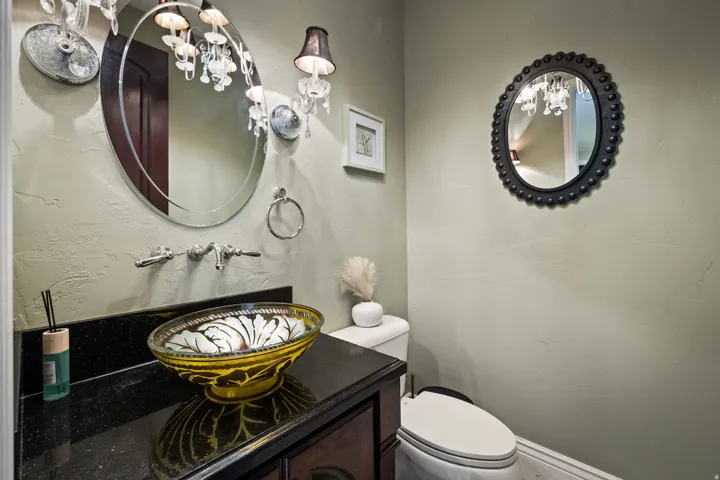 Half bath featuring vanity and a chandelier