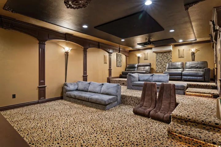 Cinema with a ceiling fan and recessed lighting