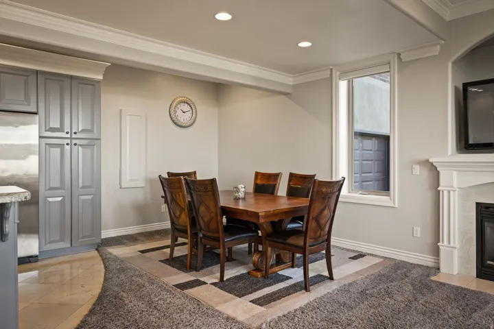 Dining room featuring ornamental molding, a tile fireplace, and recessed lighting