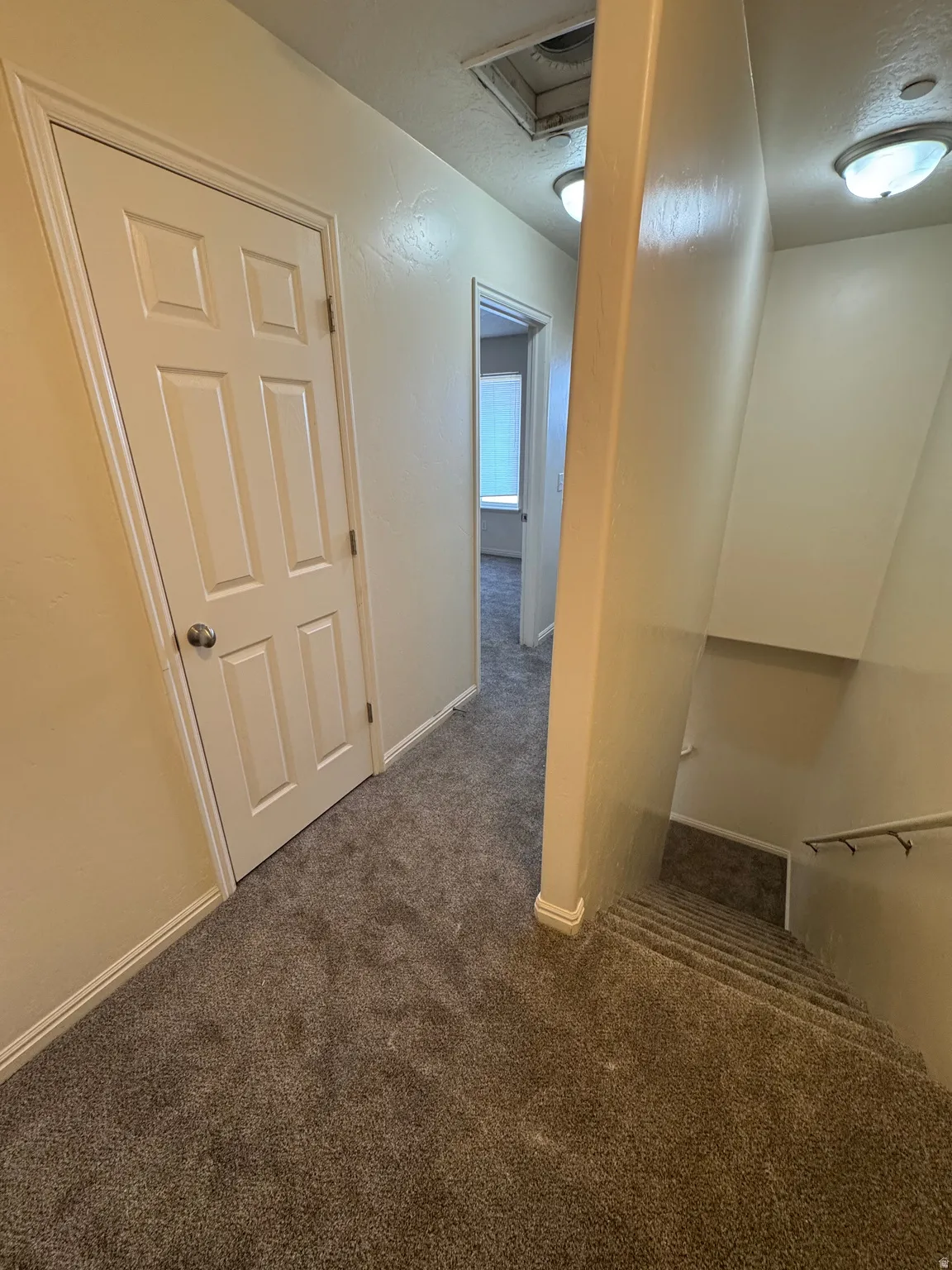 Hall featuring carpet flooring and baseboards