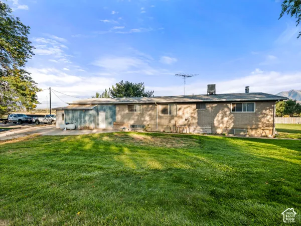 Ranch-style house with a front lawn and brick siding