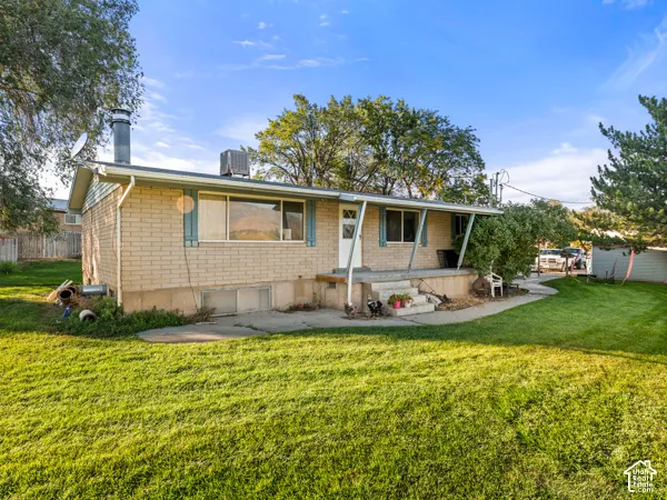 View of front of home with covered porch and brick siding