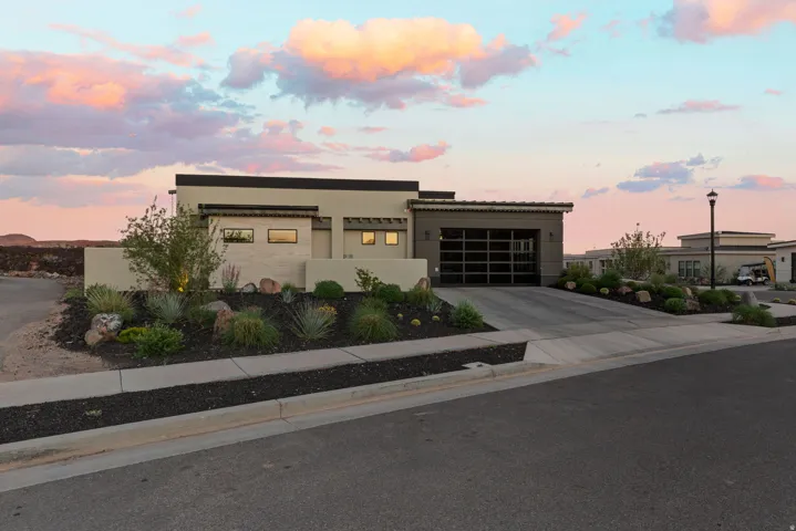 Modern home featuring driveway, stucco siding, and a garage