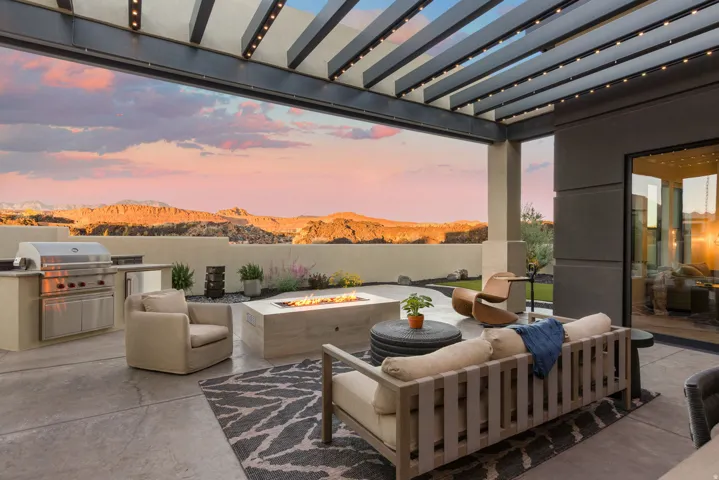 View of patio / terrace featuring a fire pit, a pergola, a mountain view, and an outdoor kitchen with living area