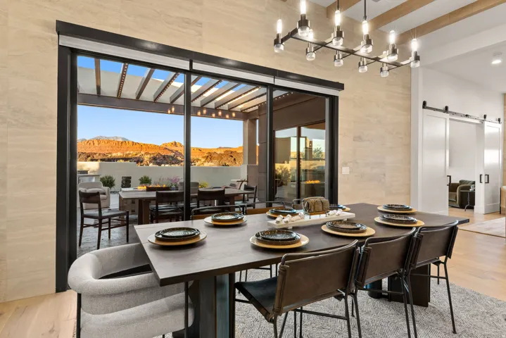 Dining area with a barn door, light wood-type flooring, and a mountain view