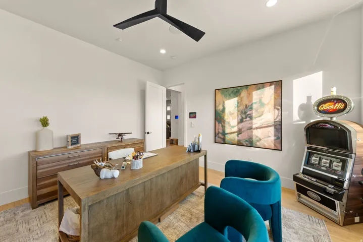 Office area with light wood finished floors, recessed lighting, and a ceiling fan