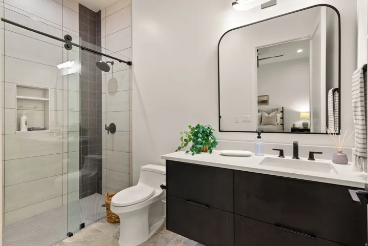 Full bath with vanity, a shower stall, and ensuite bathroom